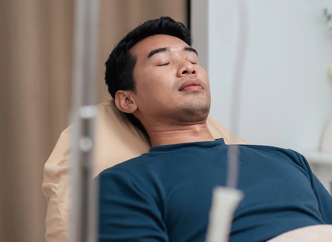Man relaxing in a recliner during IV therapy