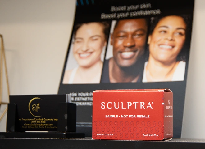 Sculptra box displayed in front of a Sculptra promotional poster