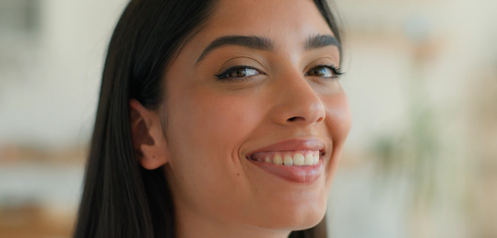 Smiling woman with smooth skin, representing Sublative RF skin resurfacing