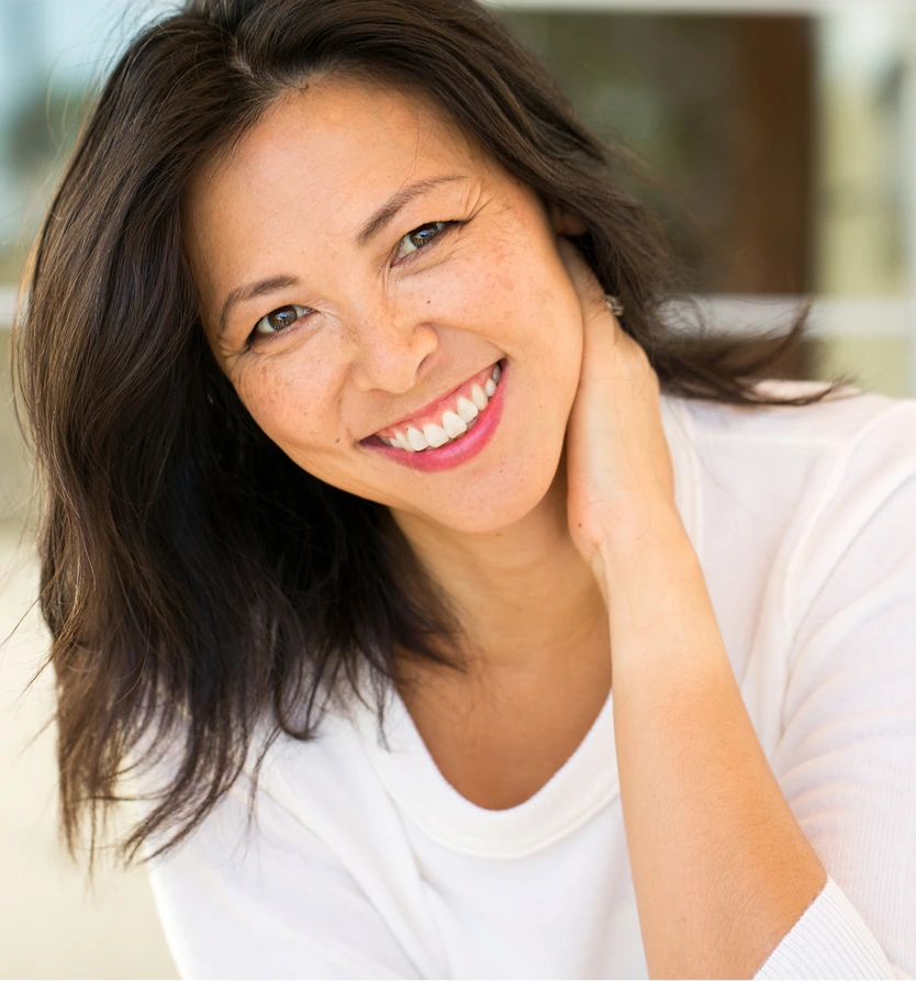 Smiling woman with radiant skin, representing collagen loss treatments in Lafayette, LA