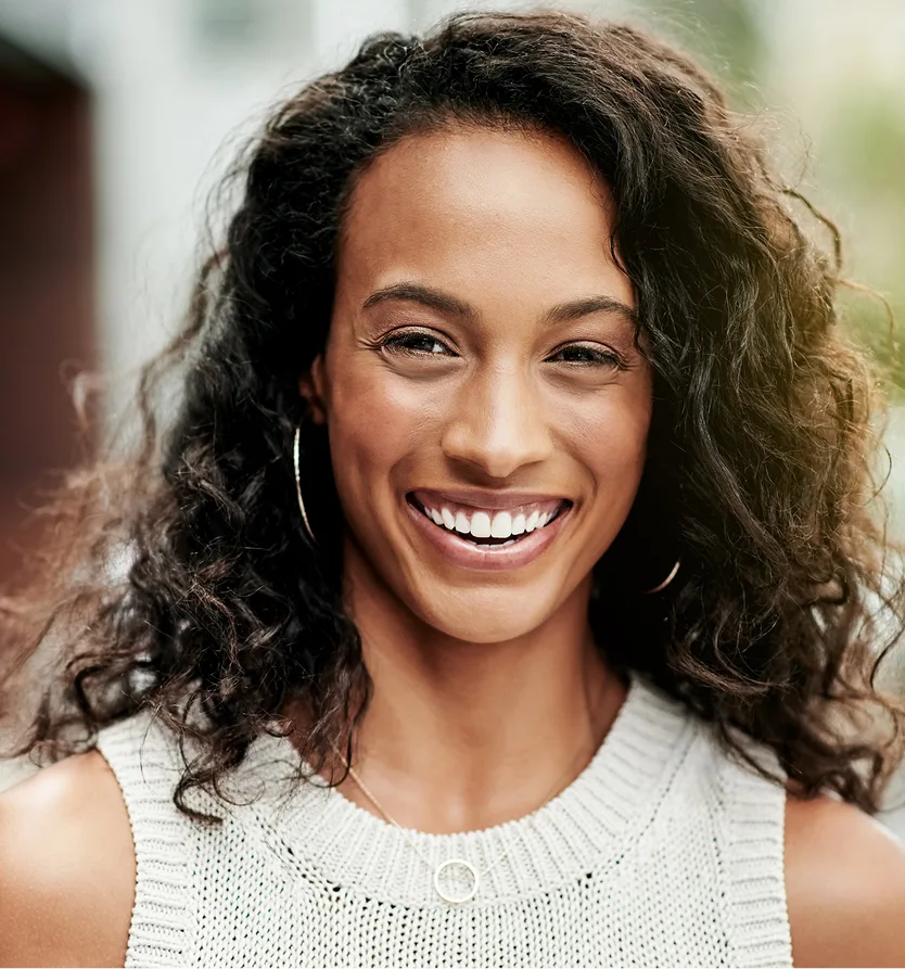Woman with glowing skin and a bright smile, representing overall skin quality care